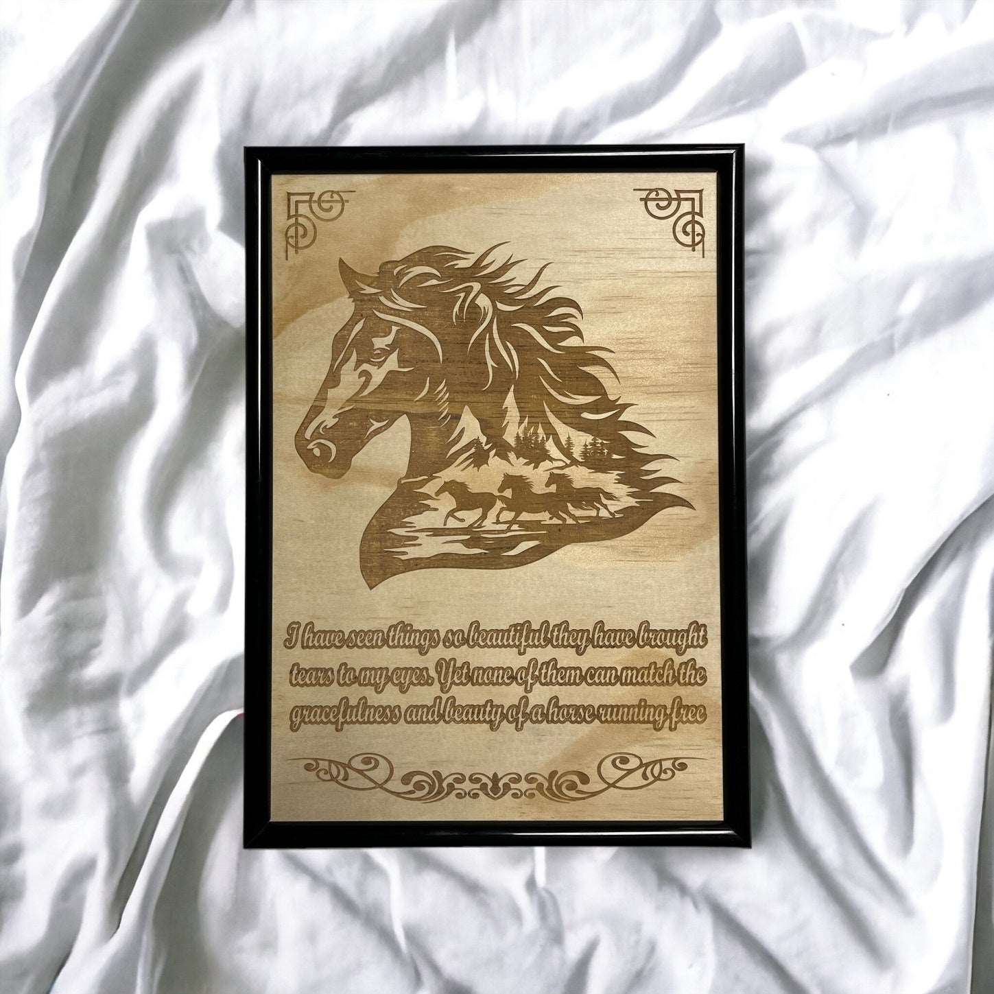 A wood-engraved artwork of a horse's head in profile, featuring a quote about wild horses, set against a background of light wood grain.