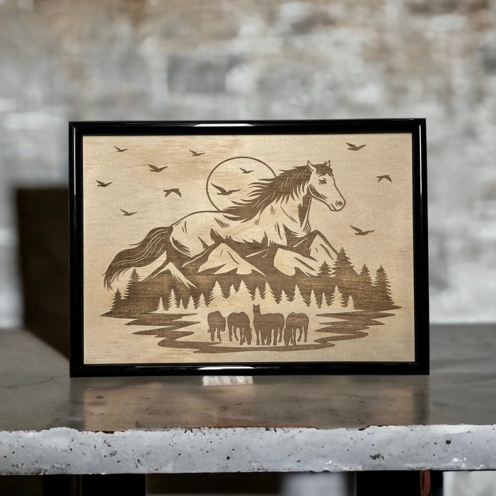 Wood engraved art featuring a horse motif with mountains, displayed in a black frame. Australian Made. Laser Design Creations.