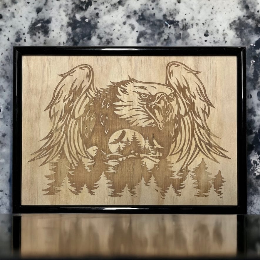 Wood-engraved artwork of an eagle with outstretched wings, framed in a black frame. Australian Made. Laser Design Creations.