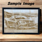 An image showing a custom car photo framed wood engraving sitting on a shelf.
