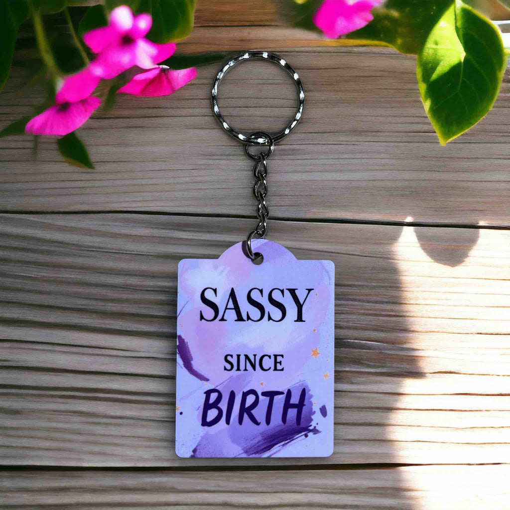'Sassy Since Birth' Keyring by Laser Design Creations, featuring a humorous purple brushstroke quote design.