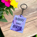 Side view of the 'Sassy Since Birth' Keyring, showcasing the bold, expressive quote art by Laser Design Creations.