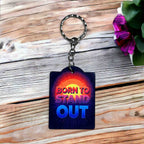 Born to Stand Out Radiant Design acrylic keyring by Laser Design Creations, featuring 'BORN TO STAND OUT' text in a bold, vibrant, and motivational style.