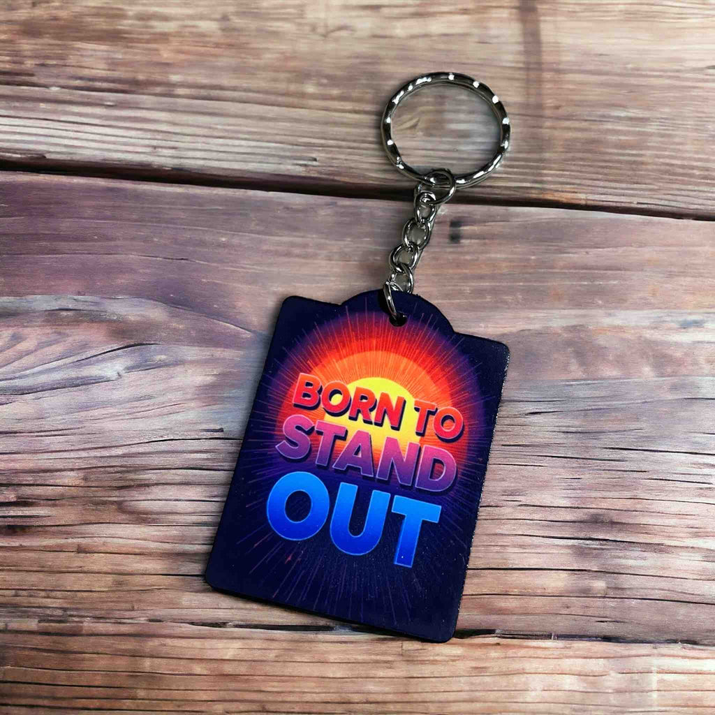 Side view of Born to Stand Out Radiant Design acrylic keyring, showcasing 'BORN TO STAND OUT' text in a bold, vibrant, inspiring style by Laser Design Creations.