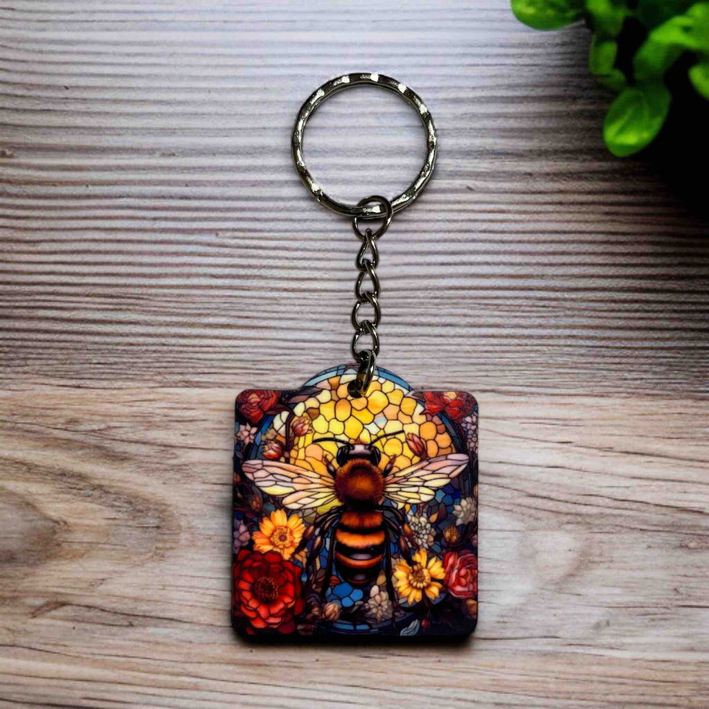 A Vibrant Mosaic Bee Floral keyring by Laser Design Creations, featuring a stunning bee within a vibrant, intricate floral mosaic, featuring a stained-glass effect.