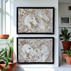 Two framed artworks of horses on a wall with plants around