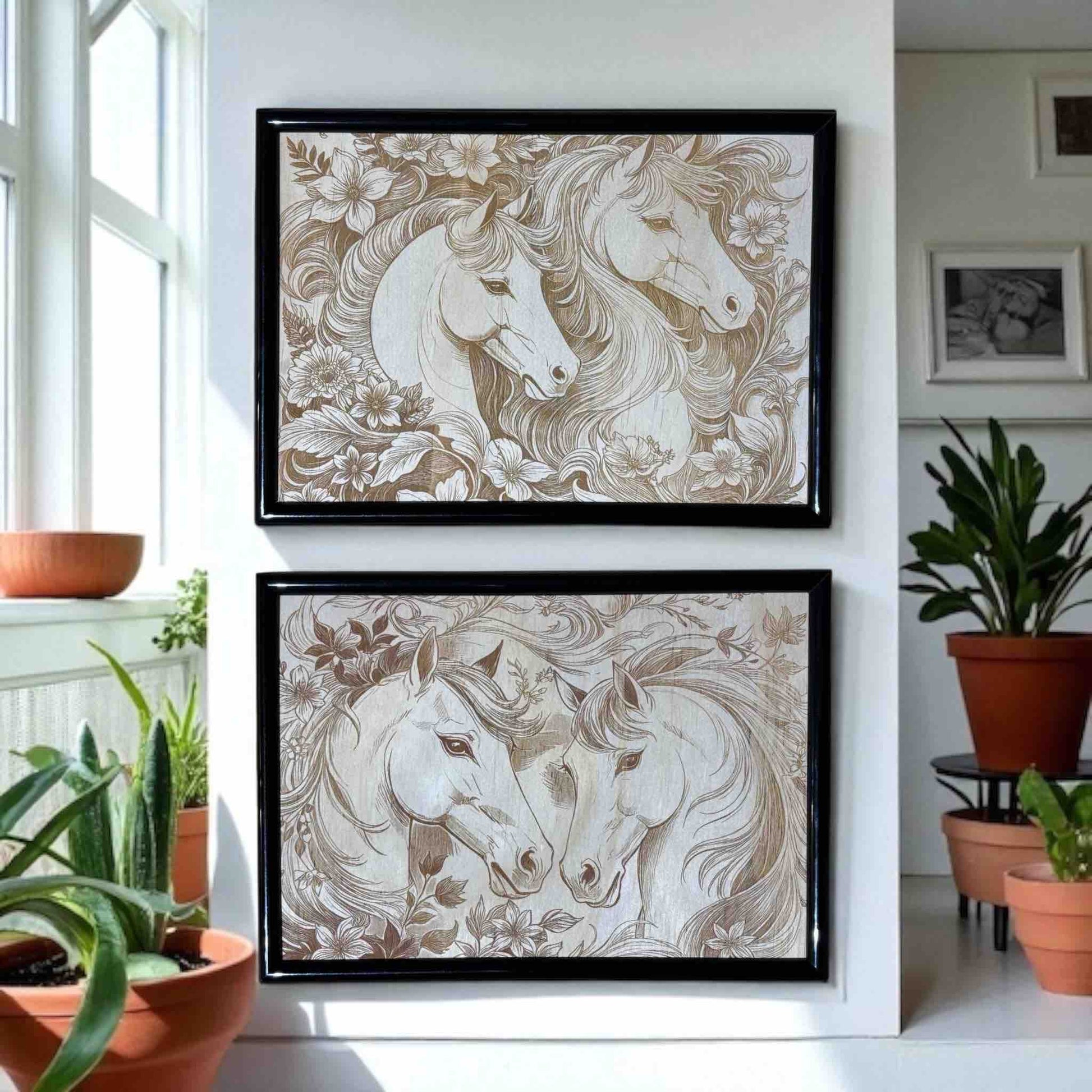 Two framed artworks of horses on a wall with plants around