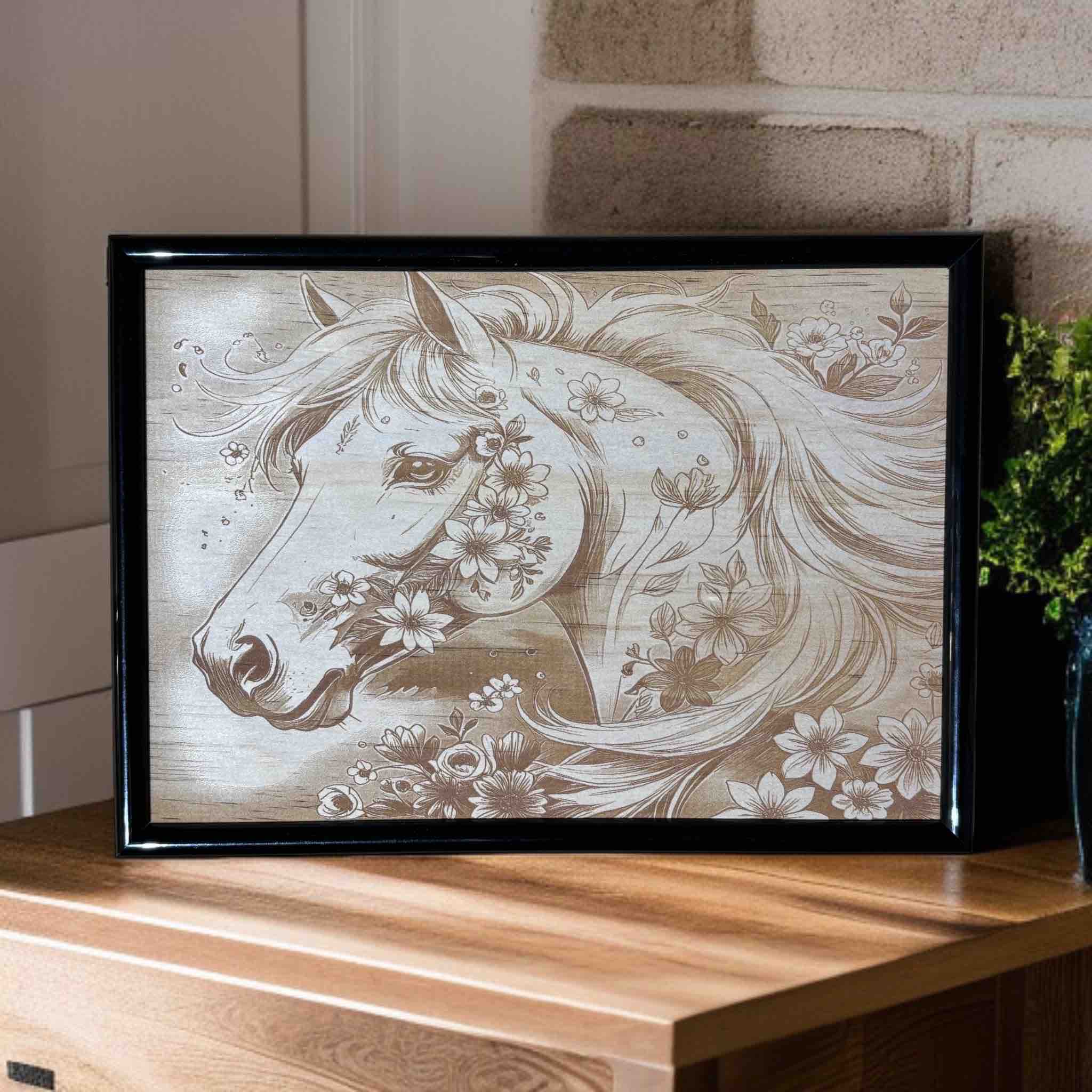 Framed artwork of a horse with floral patterns on a wooden surface.