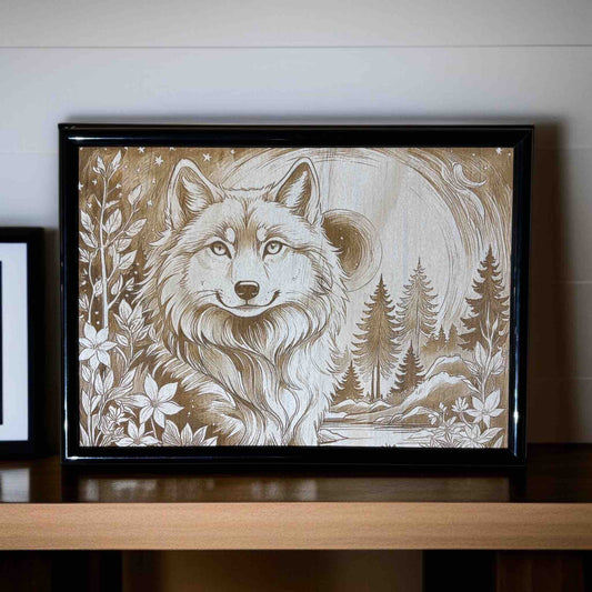 Framed artwork of a wolf with nature elements on a wooden shelf.