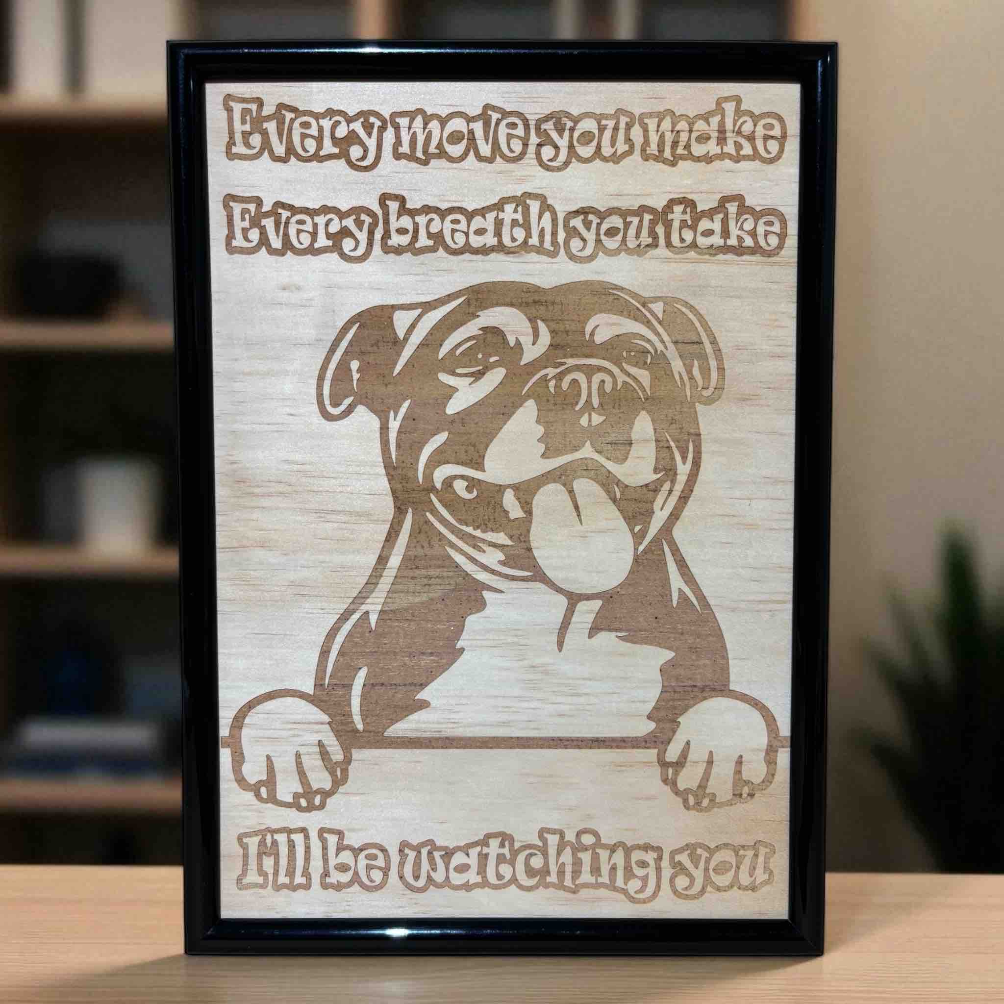 Staffy “I’ll be watching you” wood engraved sign displayed on wooden table, humorous Staffy dog wall decor, Laser Design Creations, Australia.