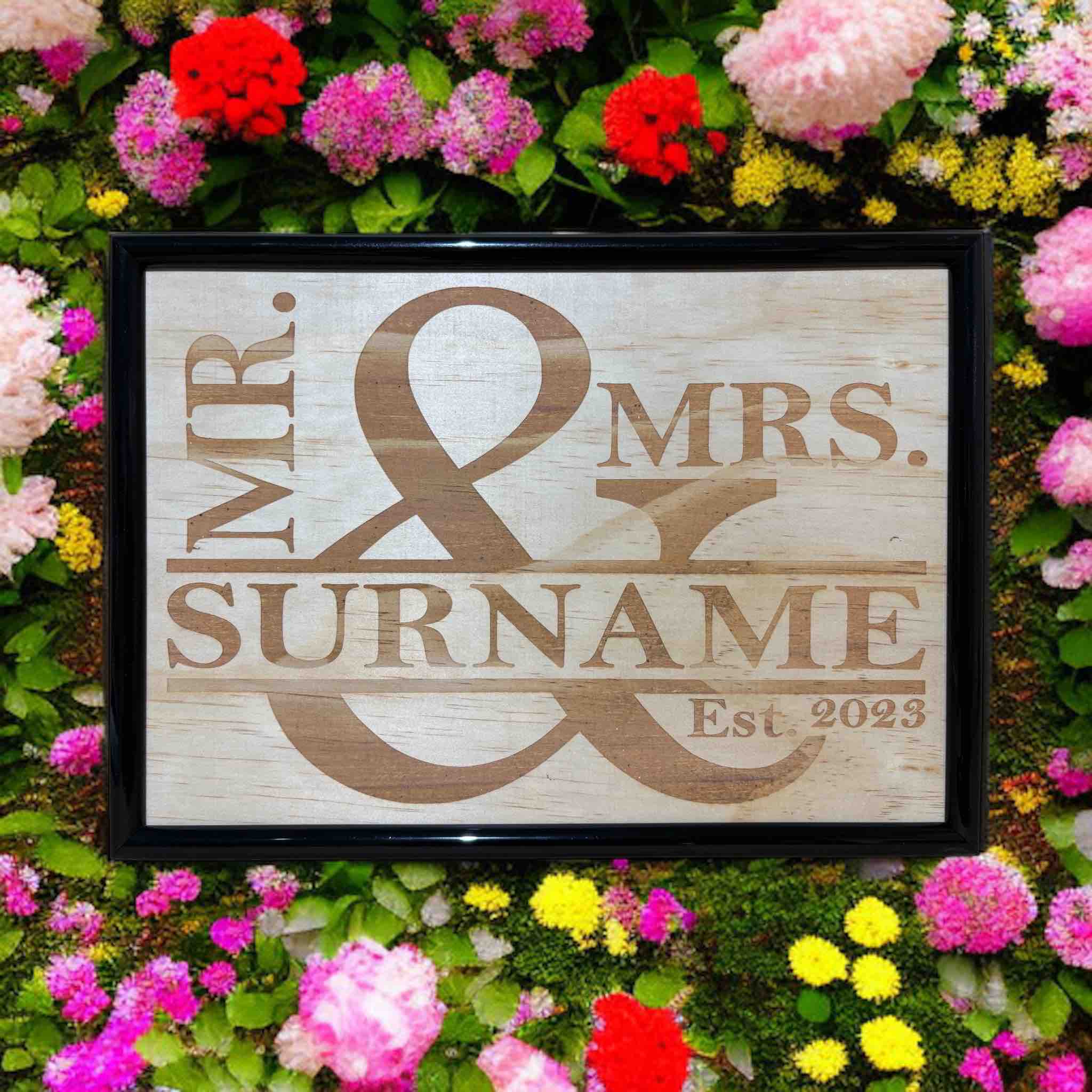 Personalised Mr & Mrs wood engraved sign displayed in flowers, rustic wedding decor, Laser Design Creations, Australia.