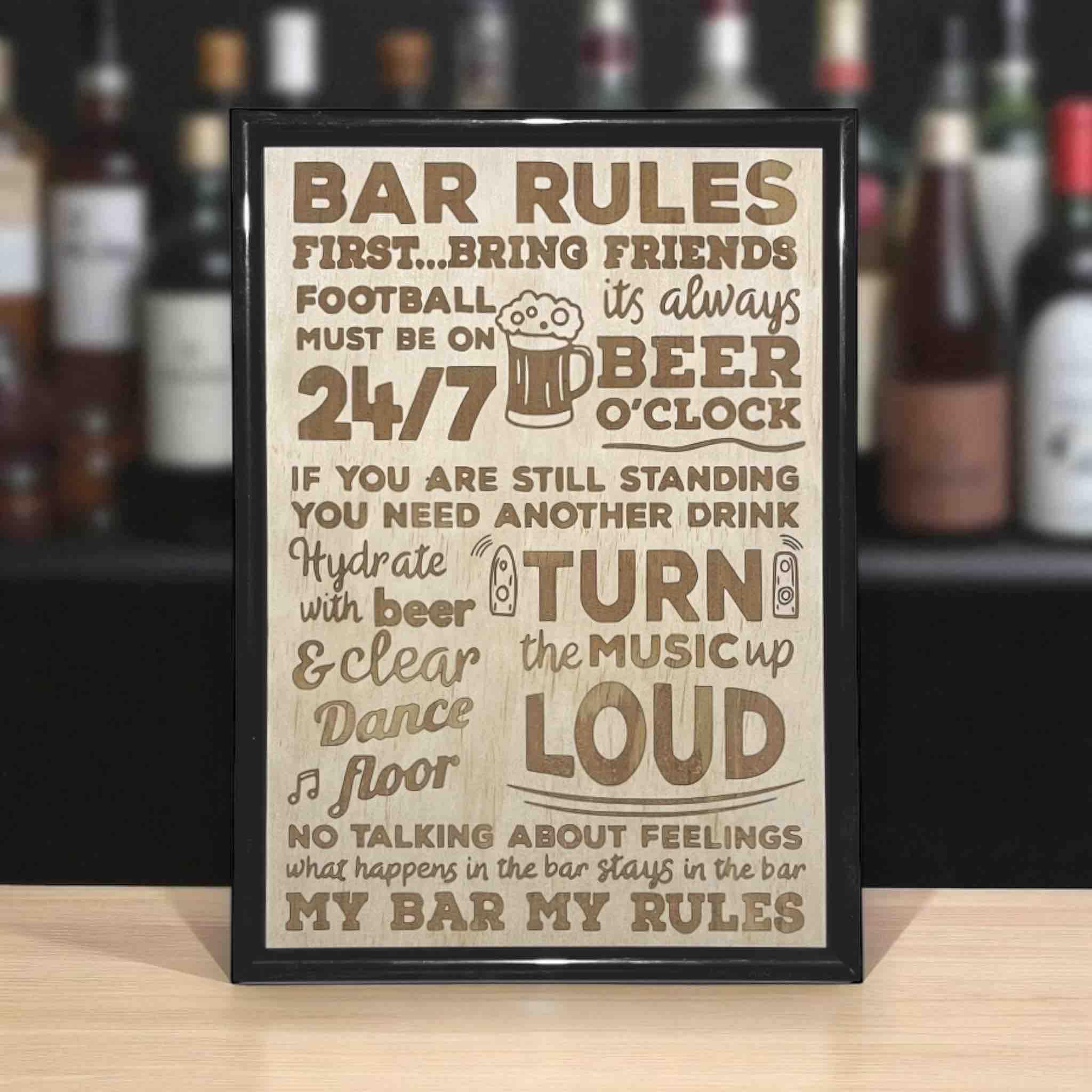 A framed wood engraved sign with 'Bar Rules' text, displayed on a wooden surface. Australian Made. Laser Design Creations.
