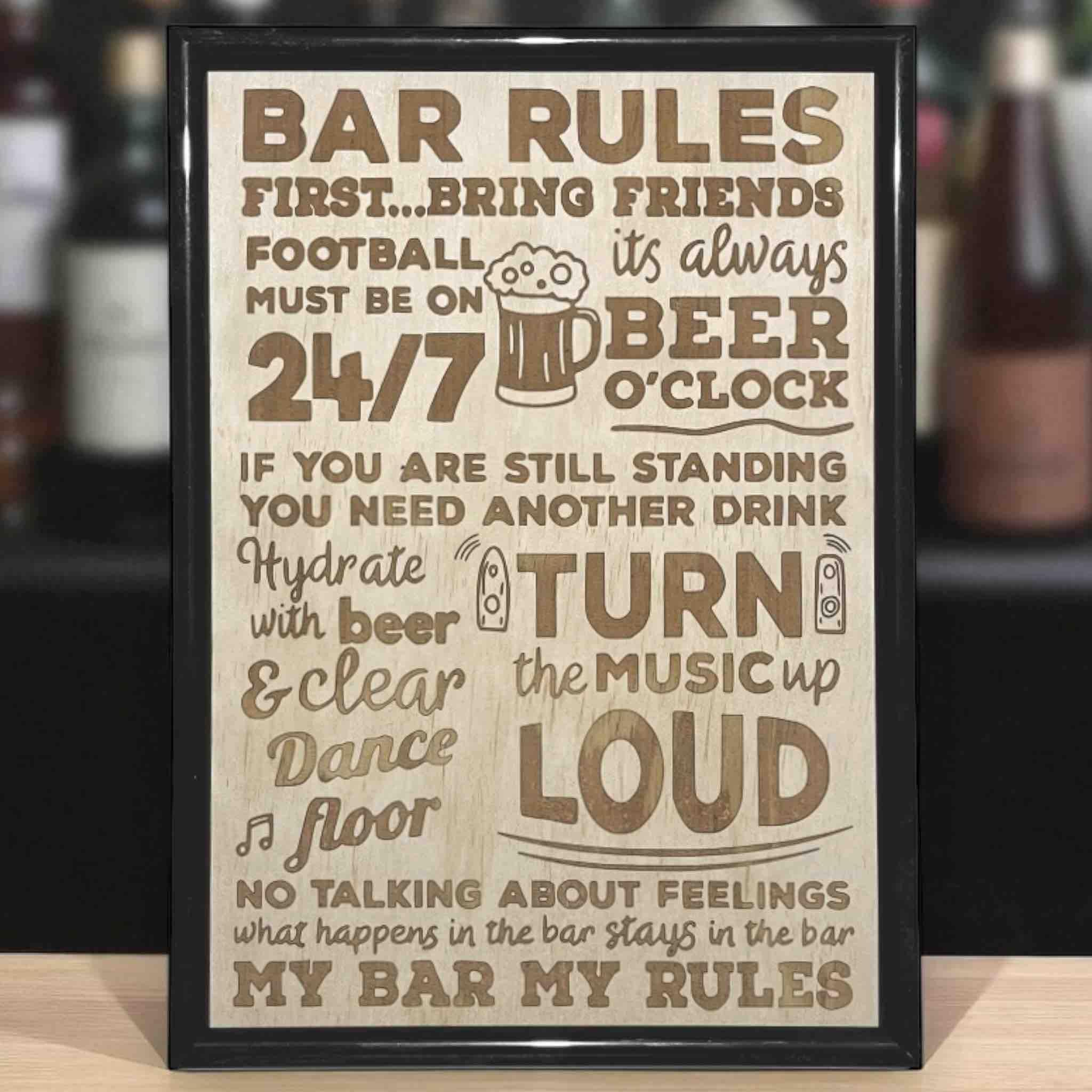 A wood engraved sign with 'Bar Rules' text, displayed on a wooden surface. Australian Made. Laser Design Creations.