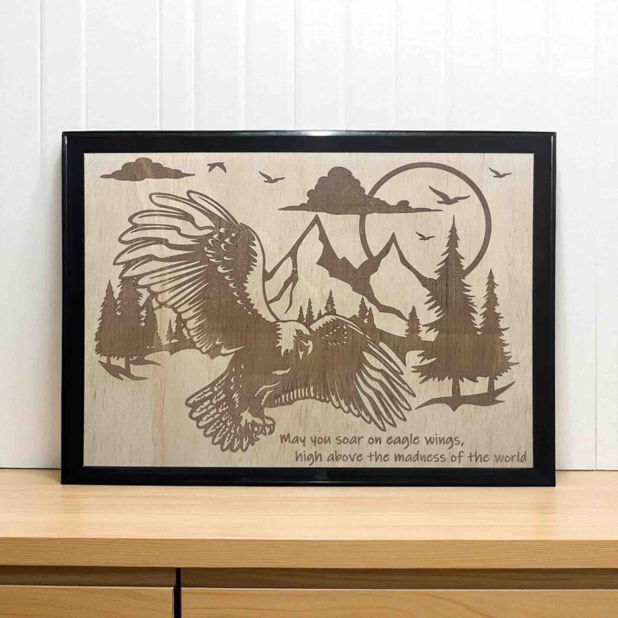 Wood engraved artwork featuring an eagle flying above a mountain range with a quote printed on it, Australian Made. Laser Design Creations.