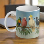 Aussie birds branch scene ceramic mug by Laser Design Creations, featuring a rainbow lorikeet, galah, cockatoo, and magpie on a gum branch.