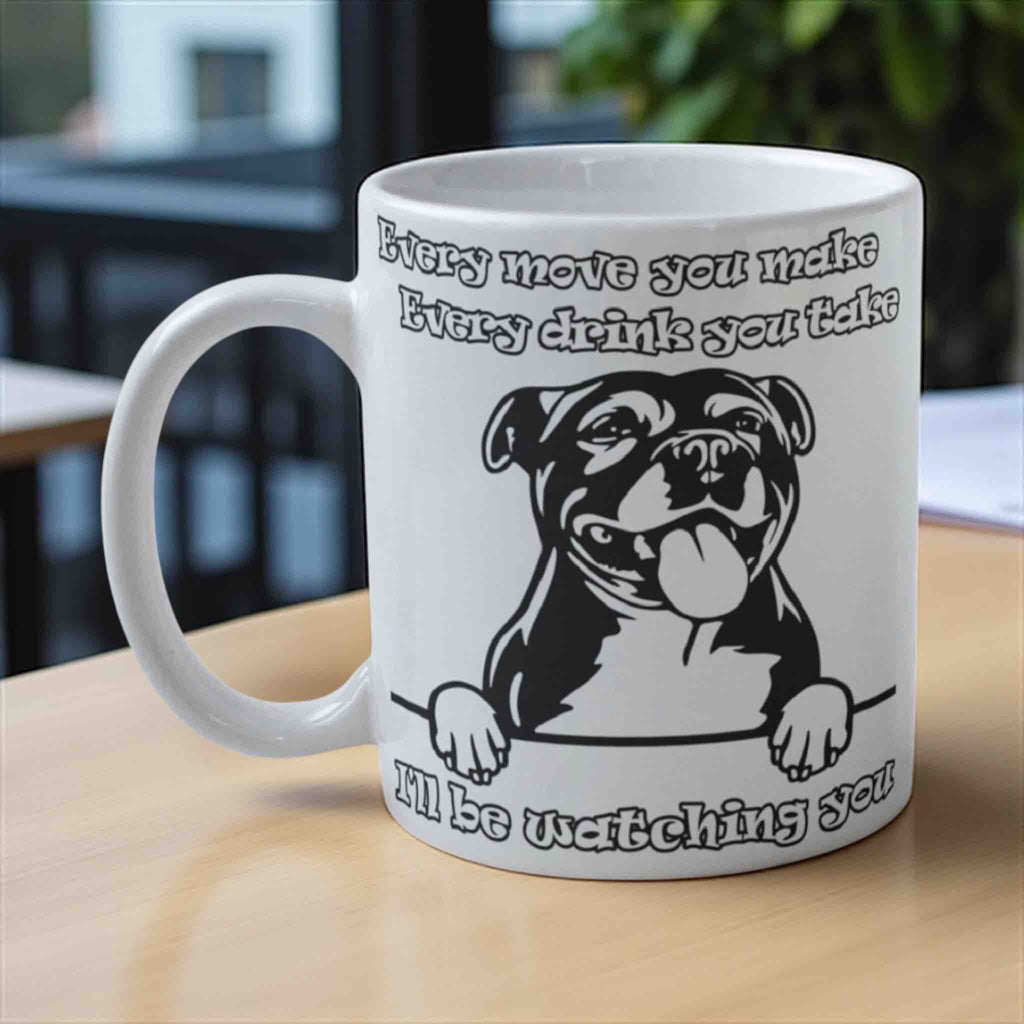 Cheeky Staffy “I’ll be watching you” ceramic mug by Laser Design Creations, featuring a playful dog illustration.