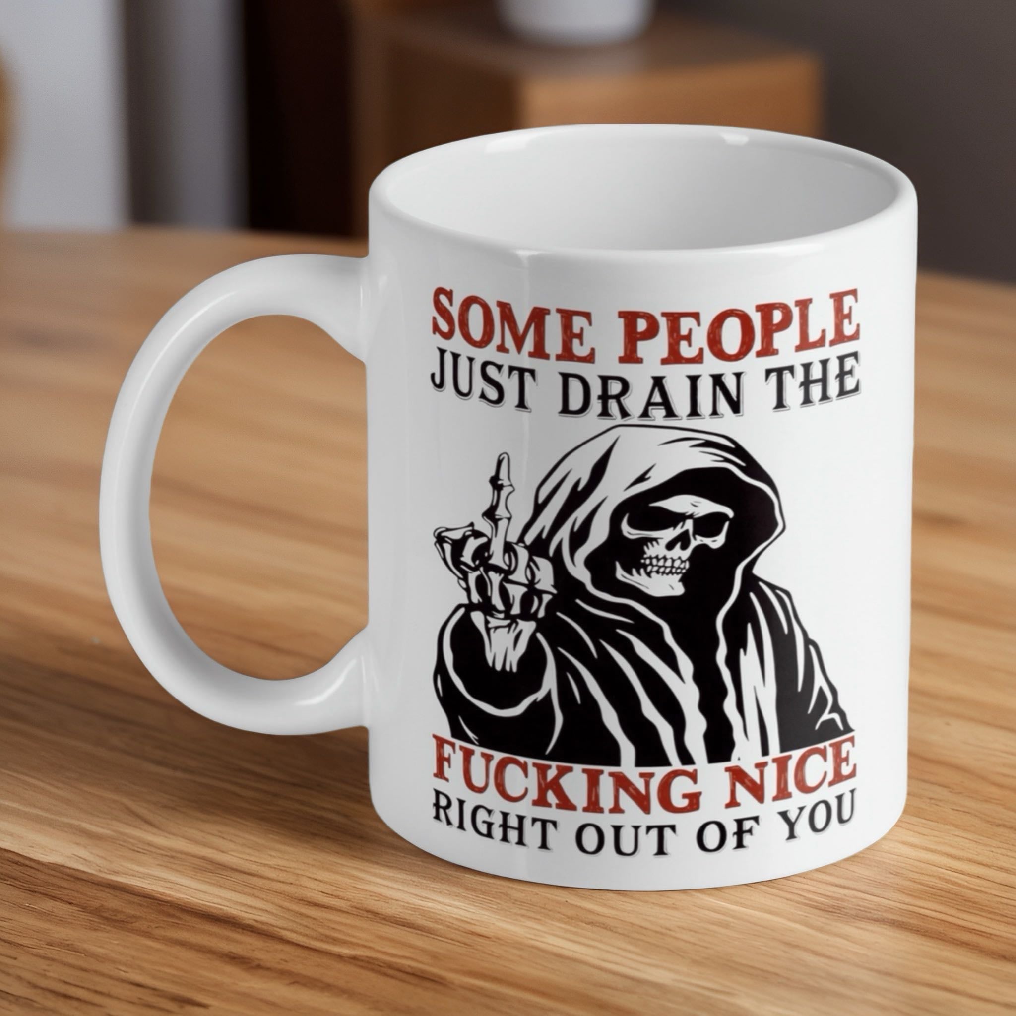 "Drain The Nice" Grim Reaper ceramic mug by Laser Design Creations, featuring a sarcastic reaper giving the middle finger.