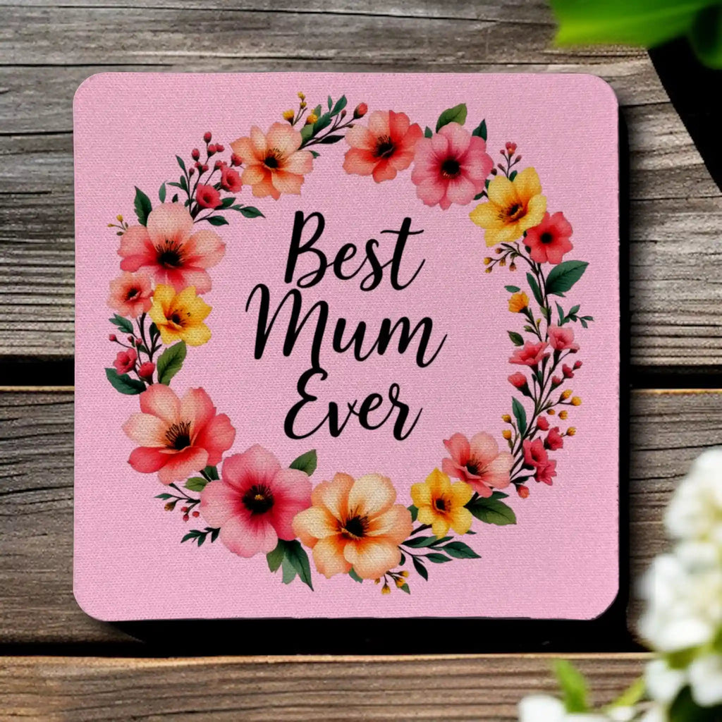 Top view of four 'Best Mum Ever' neoprene coasters with a watercolour flower design on a pink background, by Laser Design Creations.