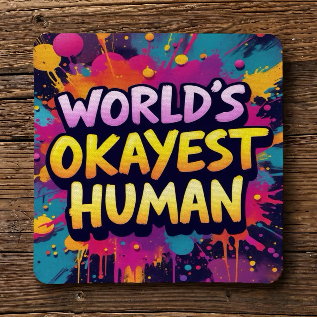 Top view of four neoprene coasters with the funny quote 'World's Okayest Human' in a street-art style, by Laser Design Creations.