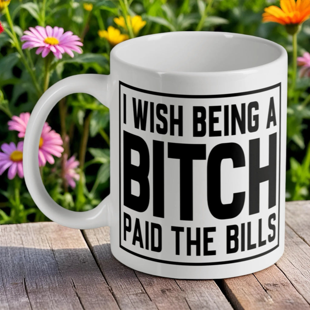 'I Wish Being A Bitch Paid The Bills' ceramic mug by Laser Design Creations, featuring bold black text on a white background.