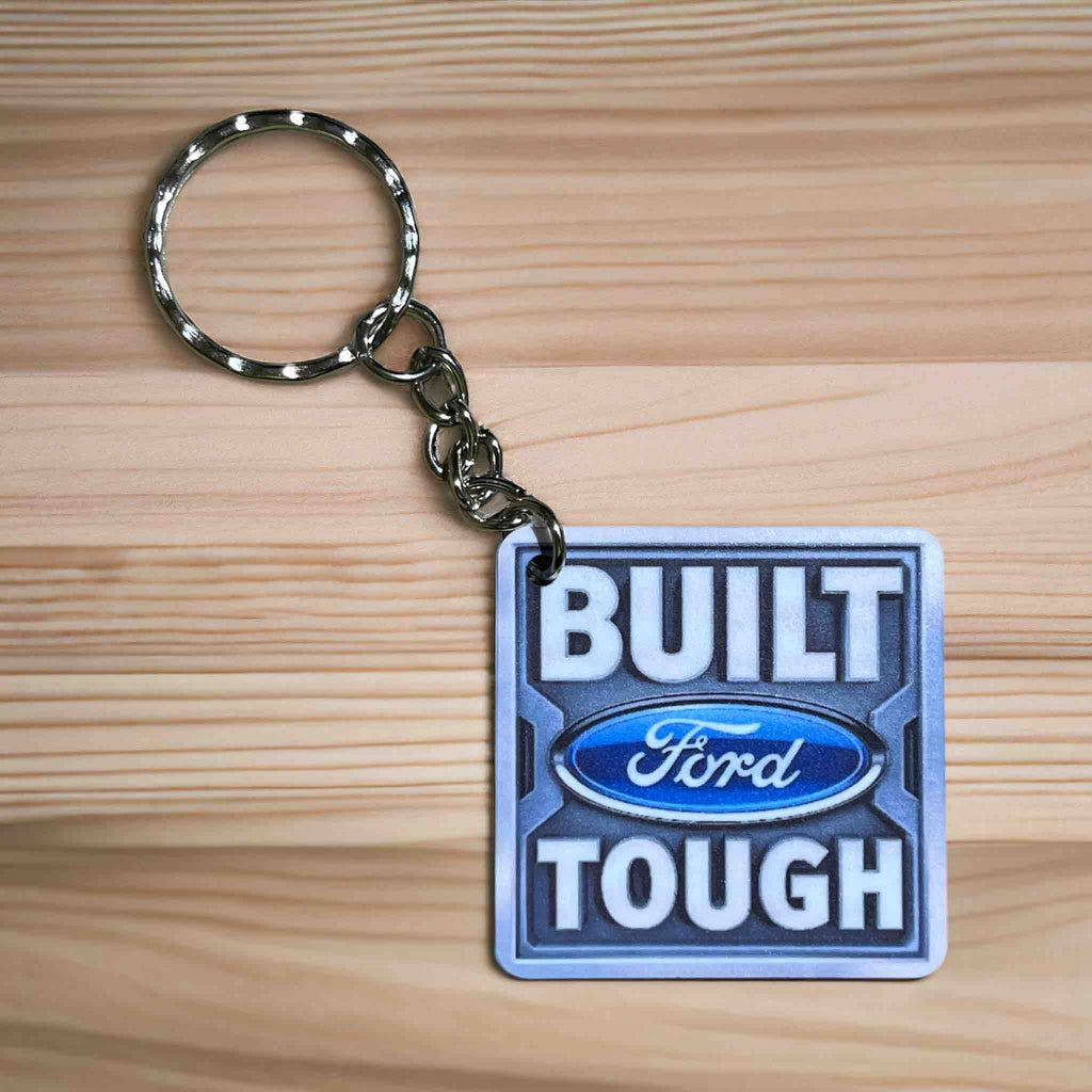 Built Ford Tough Badge Keyring by Laser Design Creations, featuring the iconic 'Built Ford Tough' quote in a simulated metallic square badge.