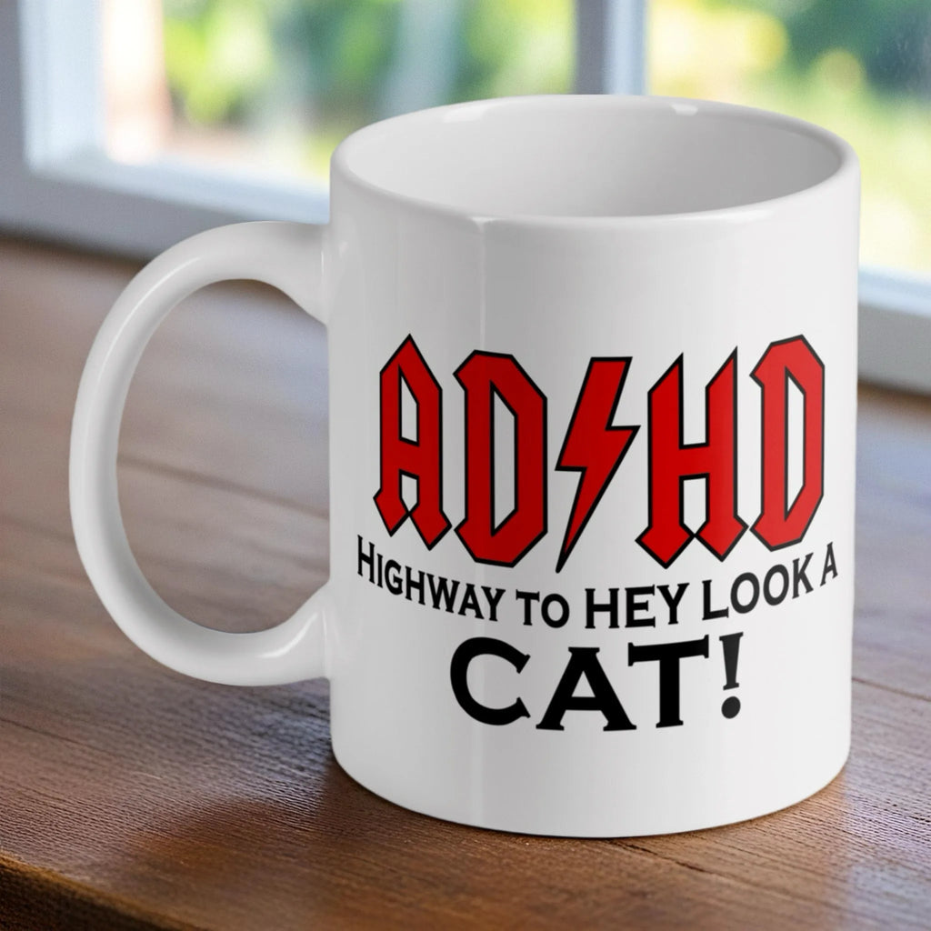ADHD Highway to Hey Look a Cat ceramic mug by Laser Design Creations, featuring a funny rock band logo parody.