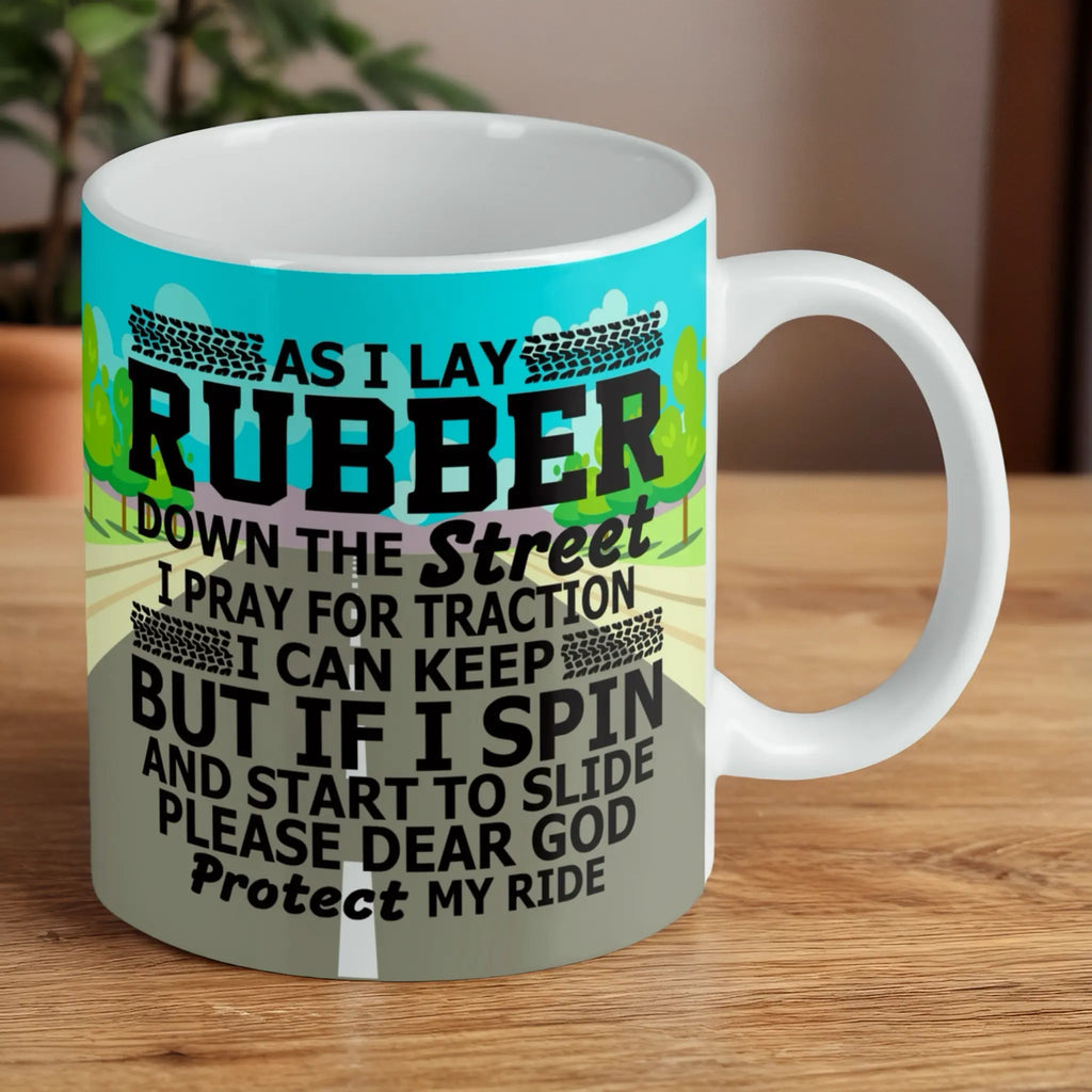 Reverse side of Protect My Ride Traction Prayer ceramic mug, showcasing the funny, bold graphic text "As I Lay Rubber Down The Street... Protect My Ride" by Laser Design Creations.