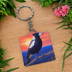 Side view of Australian Magpie Sunset Acrylic keyring, showcasing a vibrant painterly illustration of an Australian magpie perched on a branch against a sunset sky by Laser Design Creations.