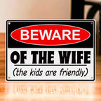 Novelty Warning Sign Parody Aluminium Sign by Laser Design Creations, featuring the quote 'BEWARE OF THE WIFE (the kids are friendly)' directed at husbands and guests.