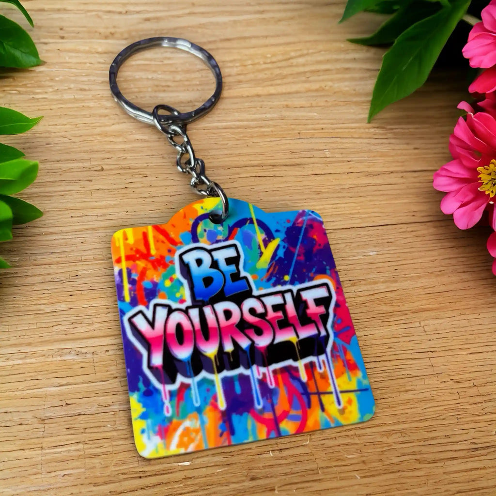 Bold Graffiti Splatter BE YOURSELF Quote acrylic keyring, showcasing vibrant street art typography and paint drip accents by Laser Design Creations.