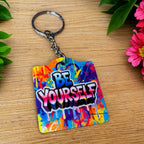 Bold Graffiti Splatter BE YOURSELF Quote acrylic keyring, showcasing vibrant street art typography and paint drip accents by Laser Design Creations.