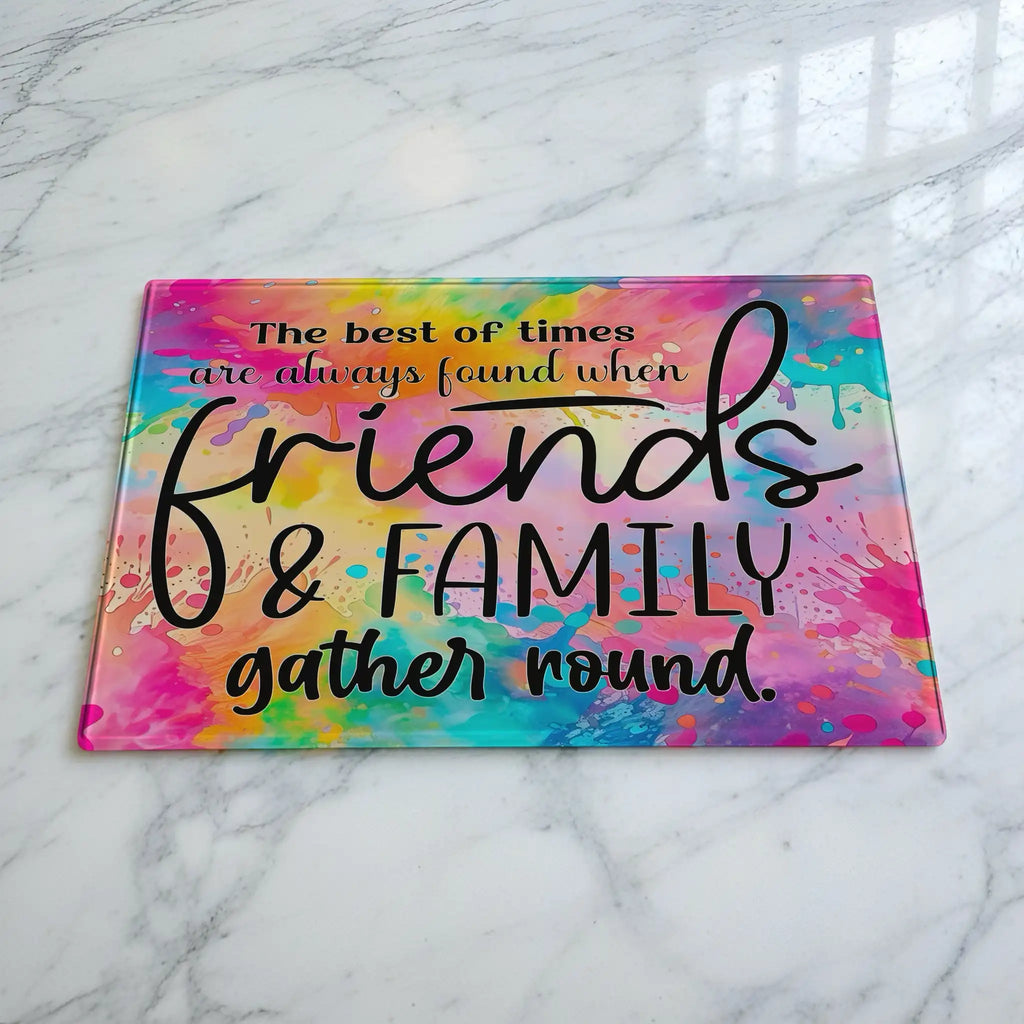 Rainbow watercolour quote glass chopping board by Laser Design Creations, featuring the quote The best of times are always found when friends and family gather round in modern calligraphy over a bright, multicoloured background.