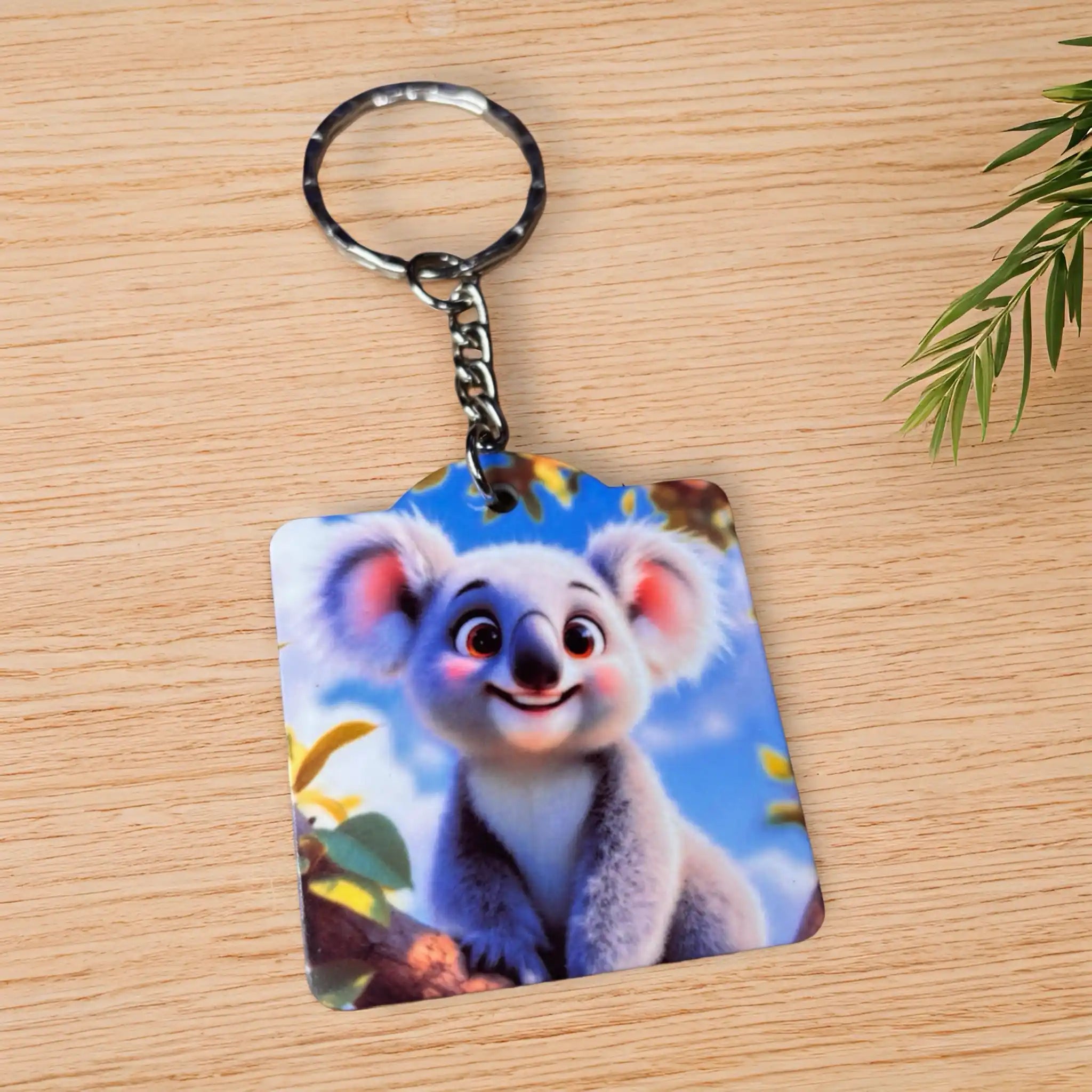 Side view of Baby Koala Branch keyring, showcasing a whimsical, adorable baby koala resting on a gum branch by Laser Design Creations.