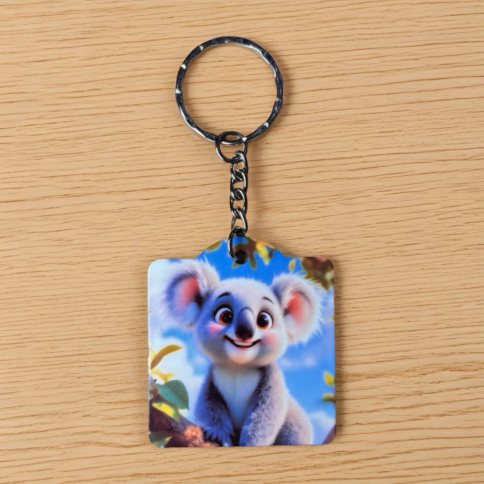 Cute Animated Baby Koala Branch keyring by Laser Design Creations, featuring a sweet, big eyed koala cub clinging to a leafy branch.