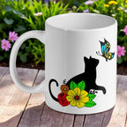 Cat and Butterfly floral ceramic mug by Laser Design Creations, featuring a black cat silhouette amongst colourful flowers.