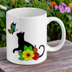 Reverse side of Cat and Butterfly floral ceramic mug by Laser Design Creations, featuring a black cat silhouette amongst colourful flowers.