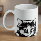 Peeking Cat ceramic mug by Laser Design Creations, featuring a cute black and white kitten illustration.