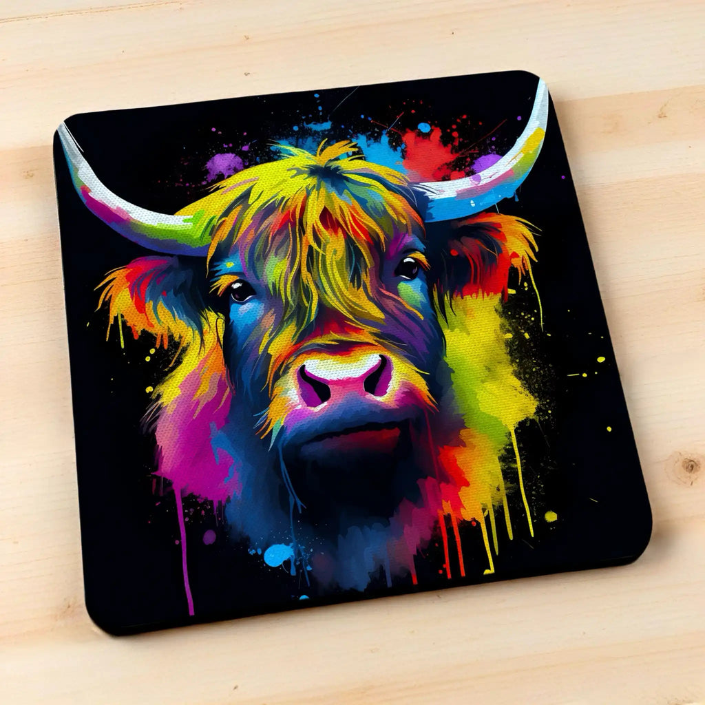 Side view of Colour Splash Highland Cow style 1 neoprene coasters, showcasing an artistic shaggy cow with vibrant paint splatters against a neutral background by Laser Design Creations.