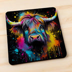 Side view of Colour Splash Highland Cow style 4 neoprene coasters, showcasing an artistic shaggy cow with vibrant paint splatters against a neutral background by Laser Design Creations.