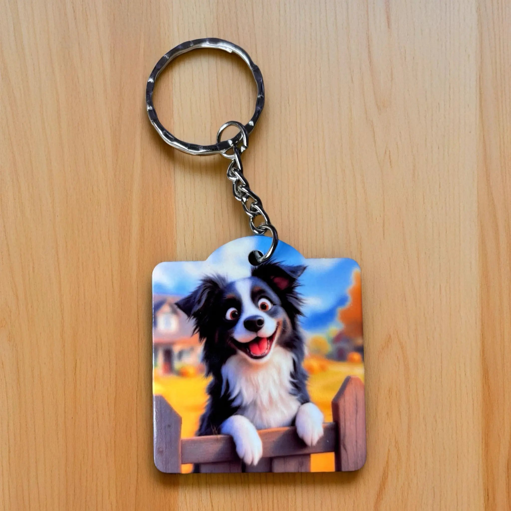 Happy Border Collie Picket Fence Cartoon keyring by Laser Design Creations, featuring an expressive, cute border collie standing in front of a white picket fence.