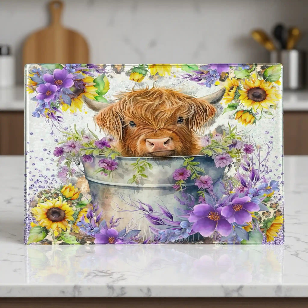 A painterly-style design of a cute Highland calf sitting in a metal bucket filled with bright yellow sunflowers chopping board from Laser Design Creations