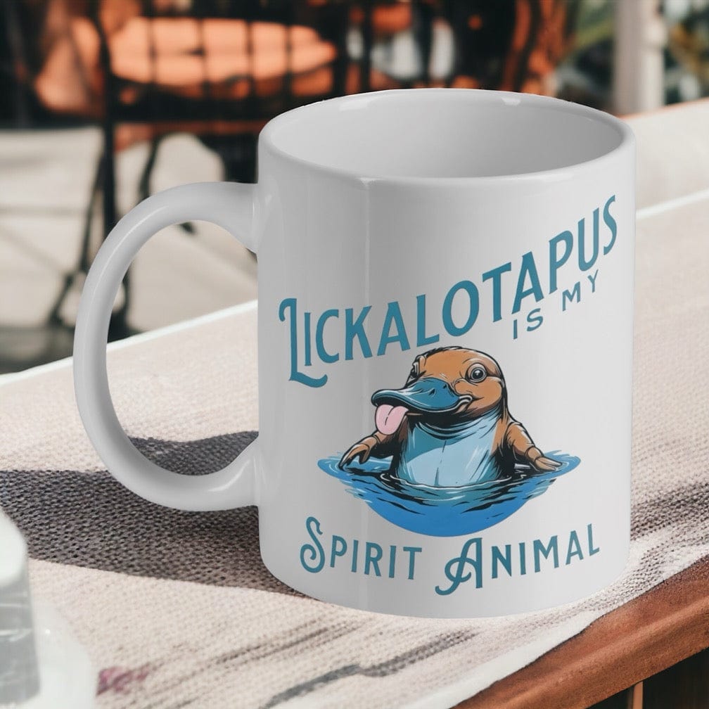 'Lickalotapus Is My Spirit Animal' ceramic mug by Laser Design Creations, featuring a funny cartoon platypus in water.