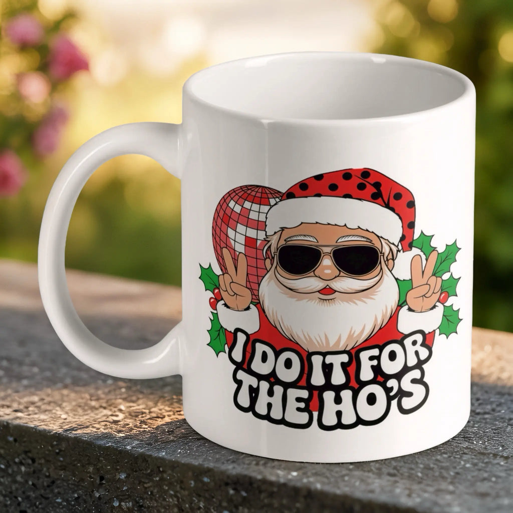 Funny Santa Disco Ball Ho's Quote ceramic mug by Laser Design Creations, featuring a crude humour Santa holding a disco ball and the text "I DO IT FOR THE HO'S".