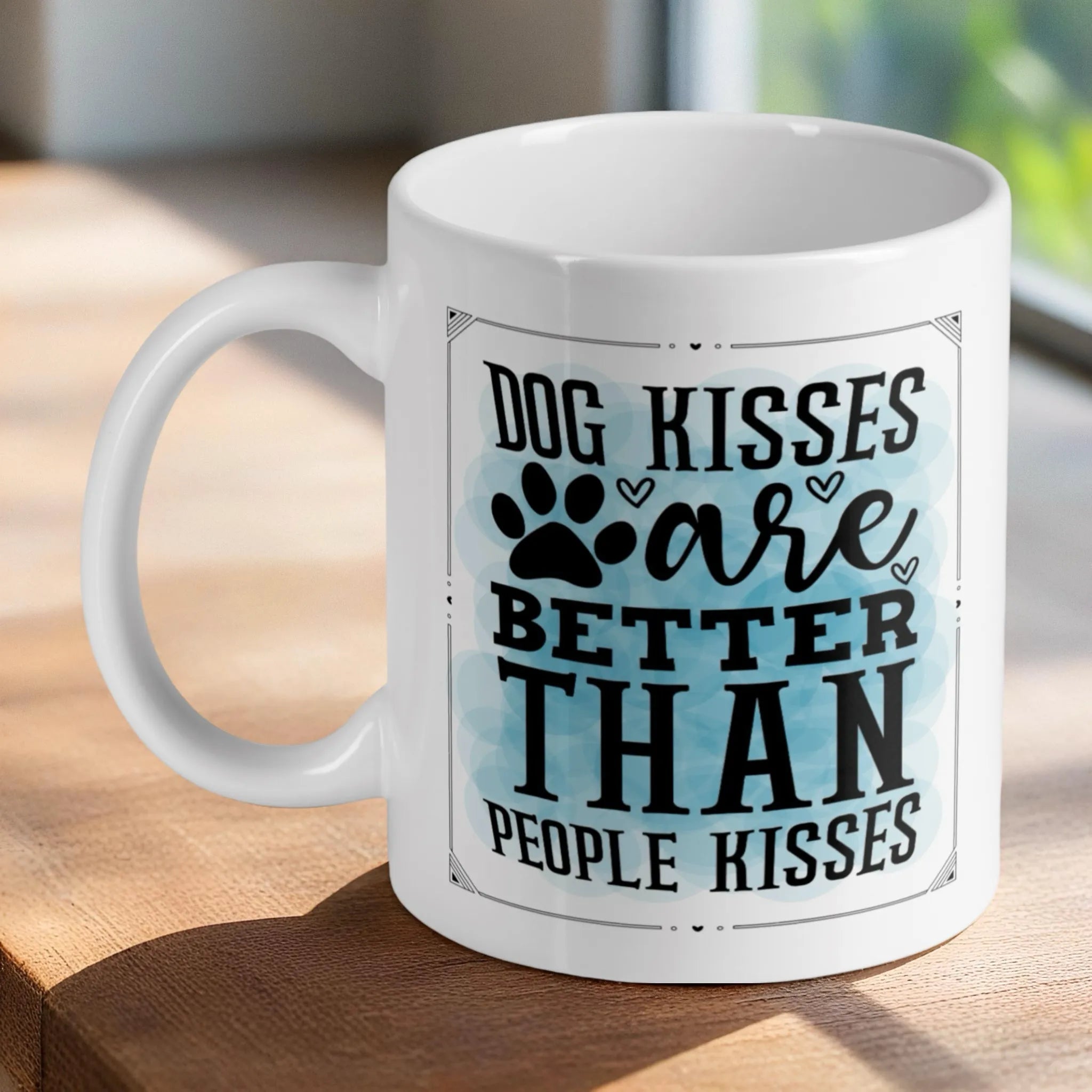 'Dog Kisses are Better' quote ceramic mug by Laser Design Creations, featuring humorous typography with a paw print accent and watercolour background.