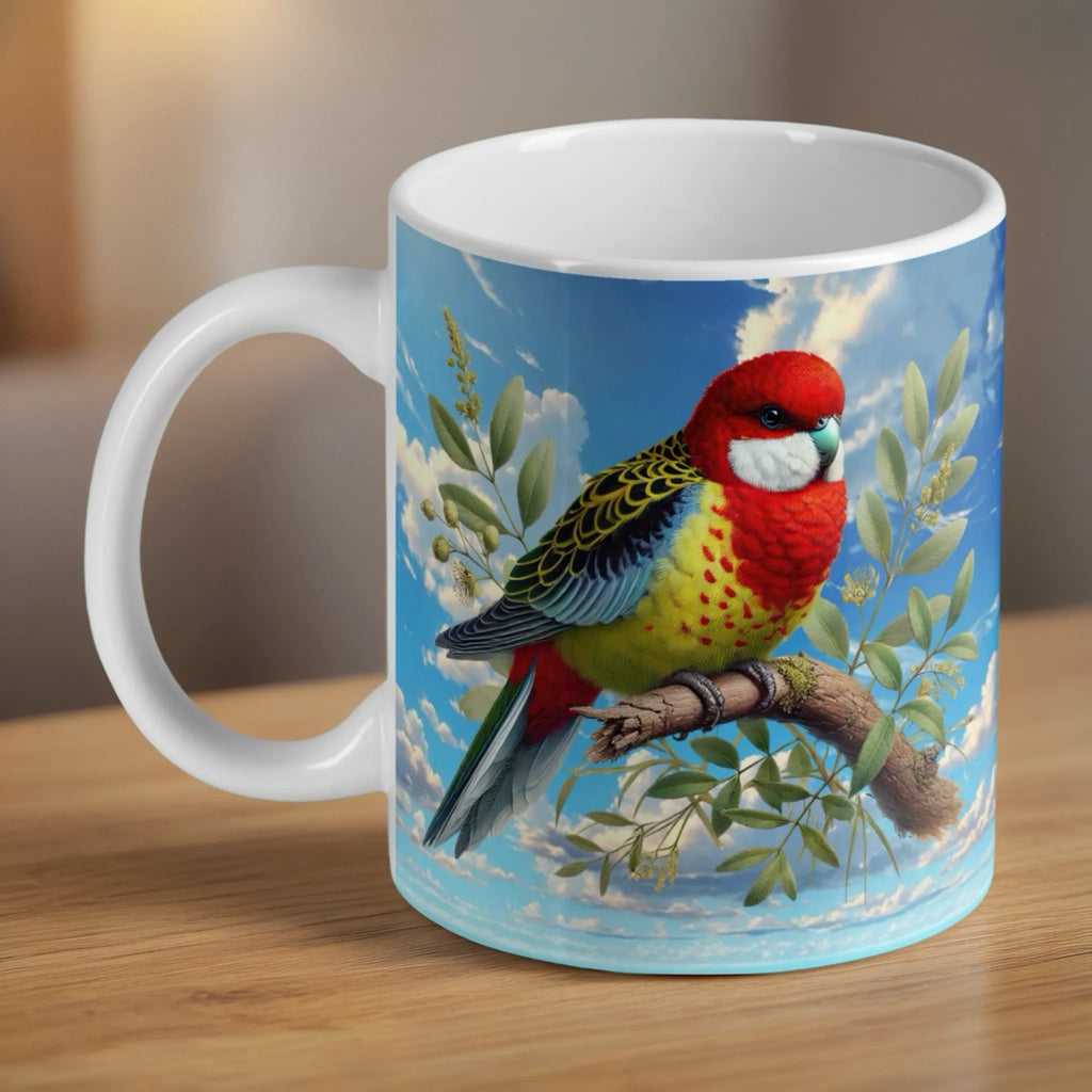 Eastern Rosella watercolour ceramic mug by Laser Design Creations, featuring a vibrant Australian parrot perched on a eucalyptus gum branch against a soft background.