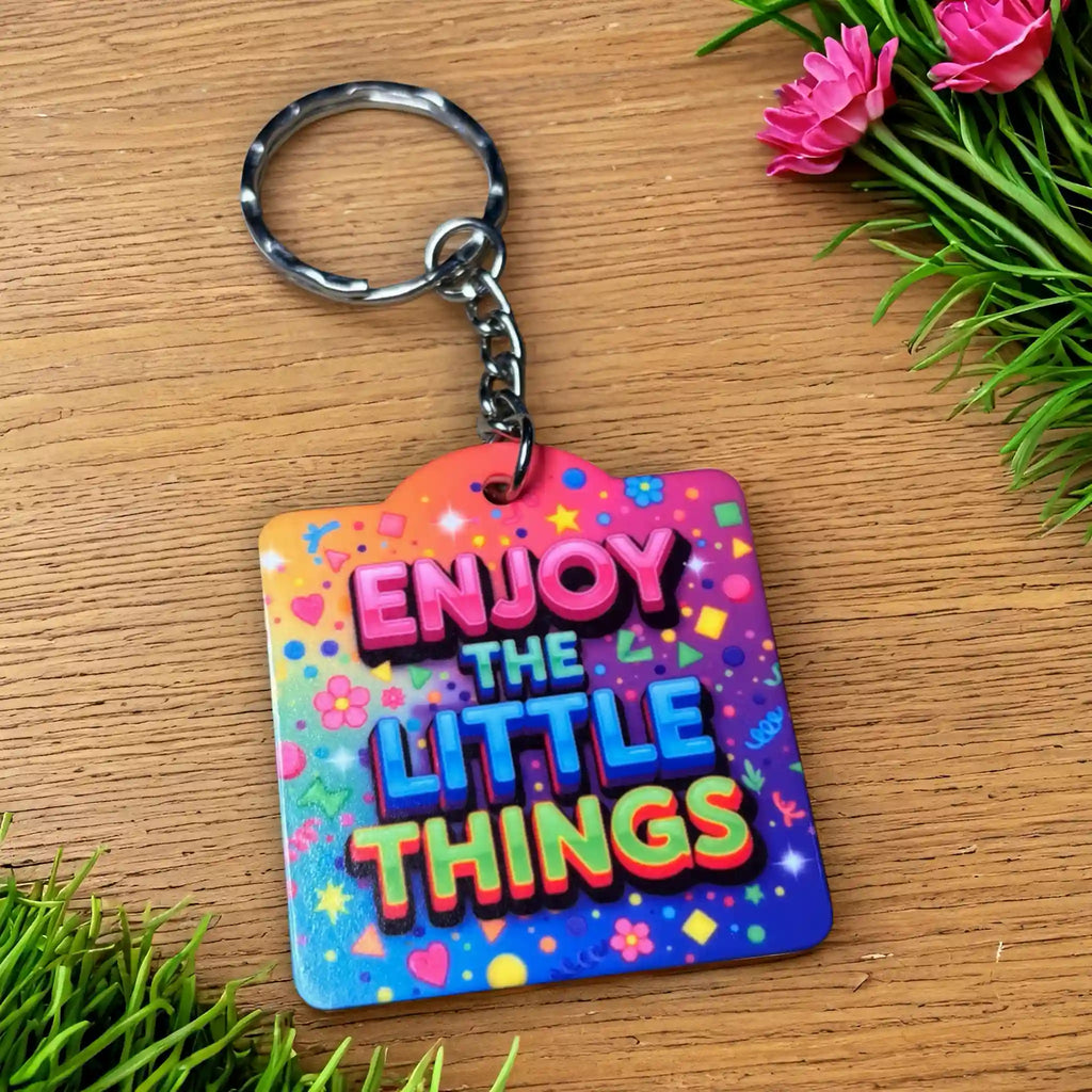 Side view of the Enjoy The Little Things - Funky Rainbow Confetti Design keyring, showcasing motivational quote typography set against a vibrant rainbow confetti background by Laser Design Creations.