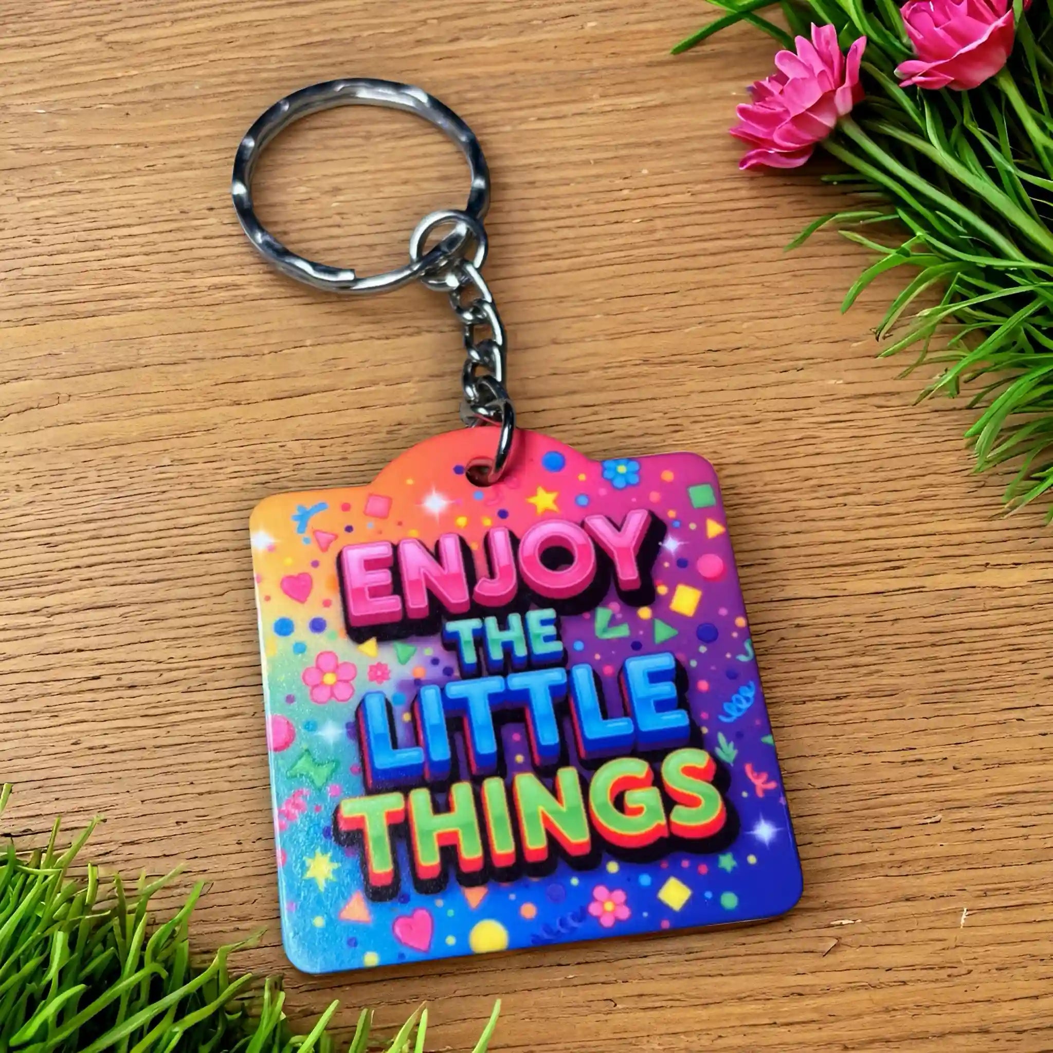 Side view of the Enjoy The Little Things - Funky Rainbow Confetti Design keyring, showcasing motivational quote typography set against a vibrant rainbow confetti background by Laser Design Creations.