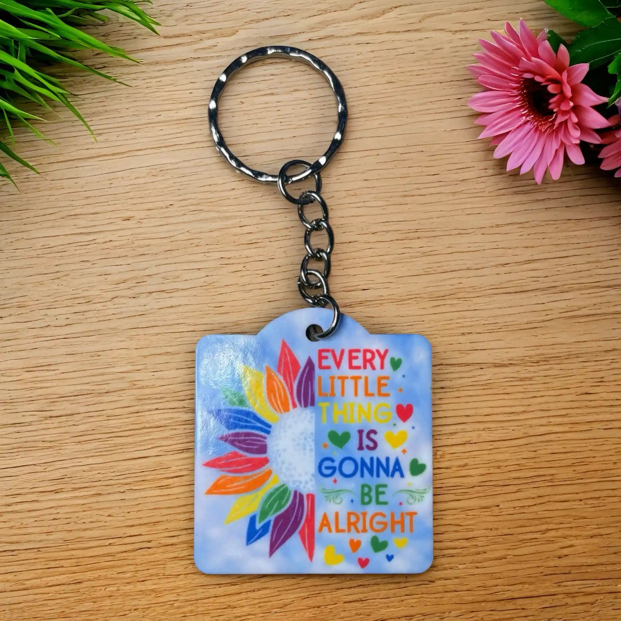 Inspirational Quote Rainbow Sunflower Keyring by Laser Design Creations, featuring the motivational quote, "EVERY LITTLE THING IS GONNA BE ALRIGHT," and happy sunflower artwork.