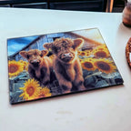 Cute Highland Calves Sunflower Farm chopping board by Laser Design Creations, featuring two adorable fluffy cows amidst a vibrant field of sunflowers.