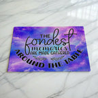 Fondest Memories Quote Purple Galaxy glass chopping board by Laser Design Creations, featuring the heartwarming quote, THE fondest memories ARE MADE GATHERED AROUND THE TABLE, set against a whimsical starry space nebula.